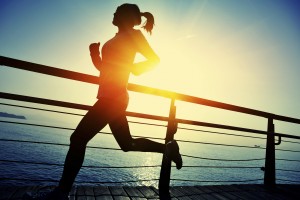 healthy lifestyle asian woman running at wooden boardwalk seaside