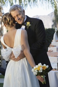 Father (facing camera) and bride dancing