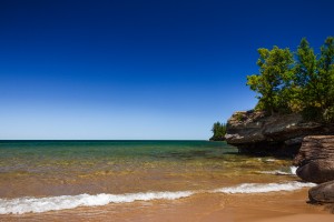 Clear Blue Sky at Sandy Beach with Rocky Coastline
